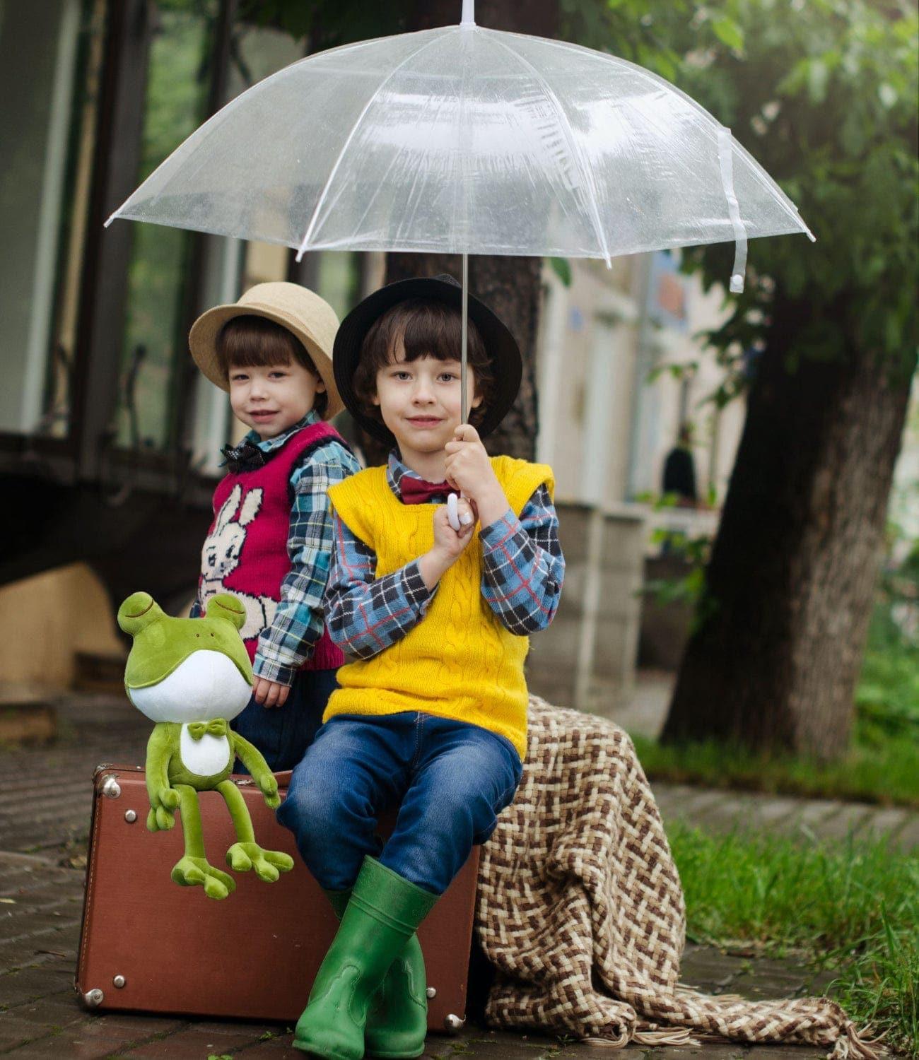 ☔ Kids sharing joyful umbrella moments with their beloved Frog Plush Friend.