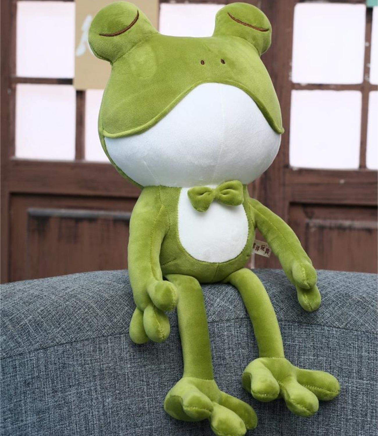 🛋️ Frog comfortably seated on a cozy sofa, adding charm to any room.
